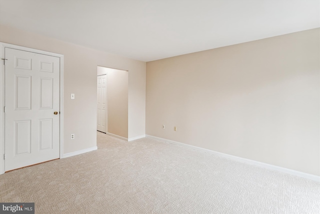 unfurnished room with light colored carpet