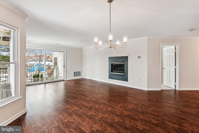 unfurnished living room featuring crown molding, a chandelier, and hardwood / wood-style floors