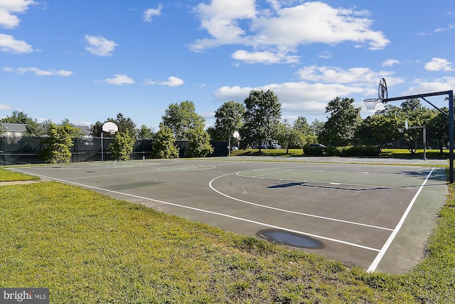 view of sport court featuring a yard