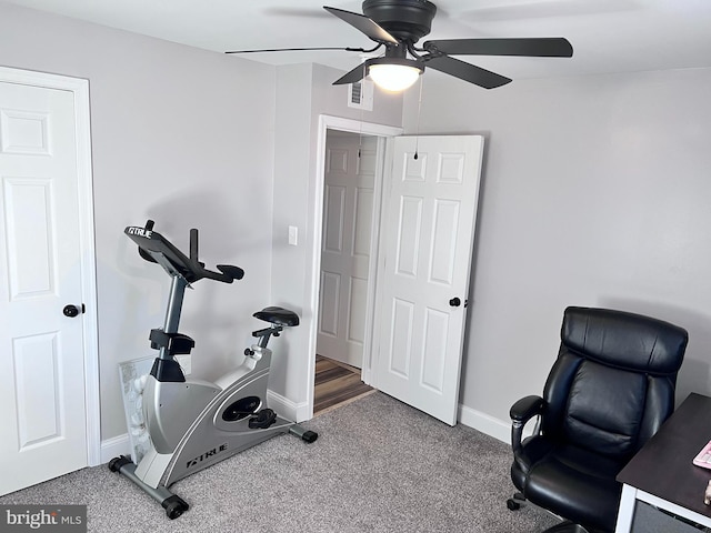 exercise room featuring ceiling fan and carpet