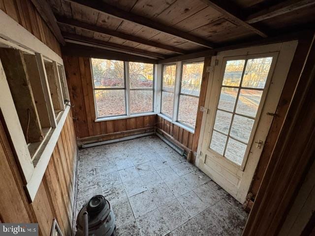 unfurnished sunroom featuring beam ceiling and wooden ceiling