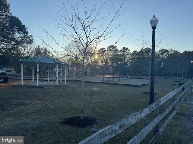 view of property's community with a lawn, a playground, and a gazebo