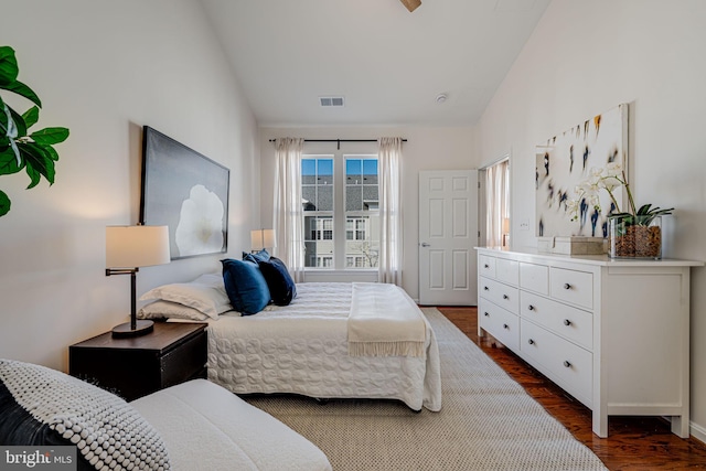 bedroom featuring dark wood-type flooring and lofted ceiling