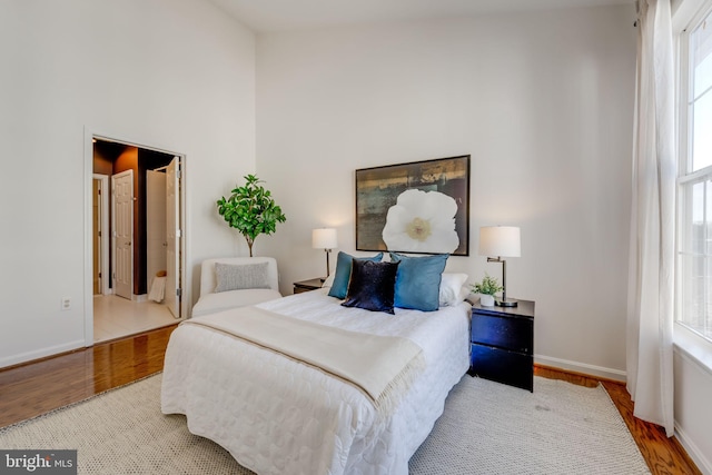 bedroom featuring hardwood / wood-style flooring and multiple windows