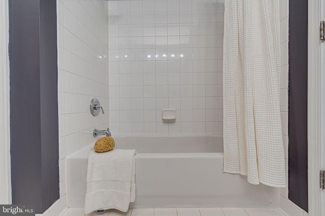 bathroom with tile patterned floors and shower / tub combo