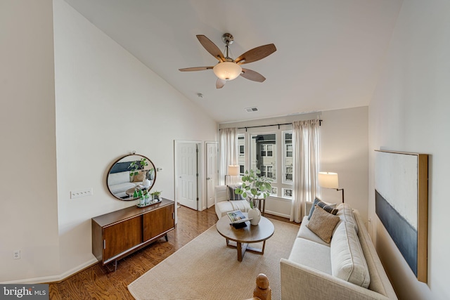 living room featuring wood-type flooring, lofted ceiling, and ceiling fan