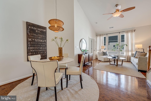 dining room featuring ceiling fan, high vaulted ceiling, and hardwood / wood-style floors