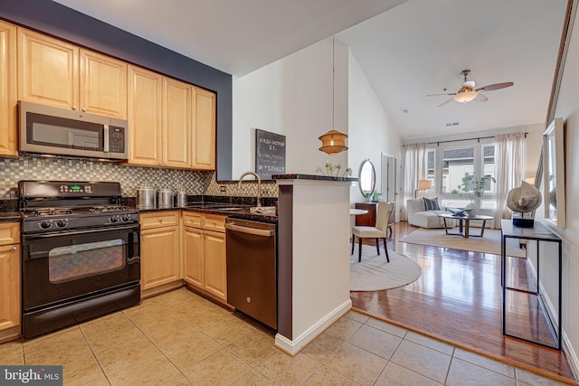 kitchen with appliances with stainless steel finishes, light brown cabinetry, decorative light fixtures, backsplash, and light tile patterned floors