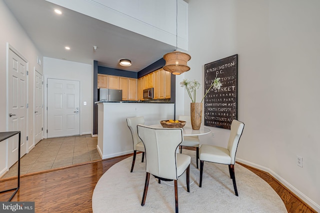 dining space with light hardwood / wood-style flooring