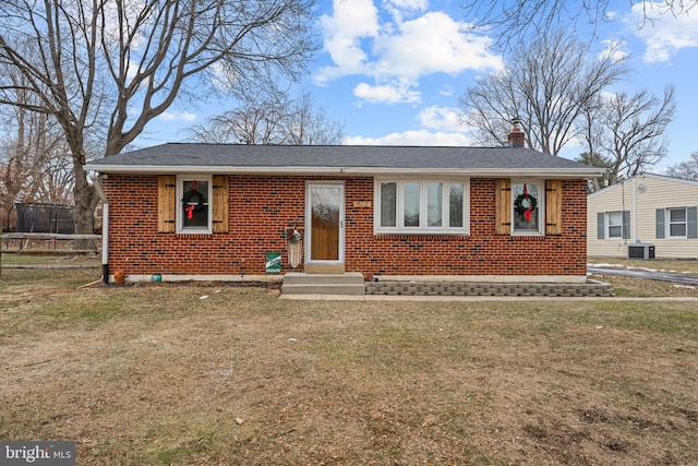 view of front of property with a front lawn and central AC unit