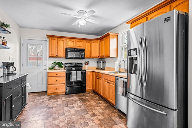 kitchen featuring ceiling fan, black appliances, and sink