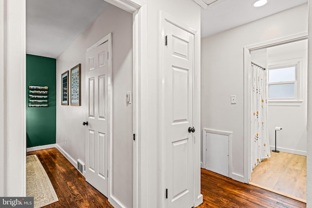 hall with dark hardwood / wood-style floors