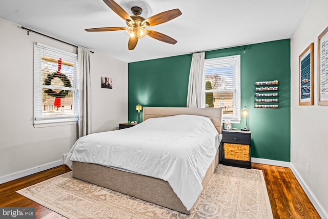 bedroom featuring ceiling fan and dark hardwood / wood-style flooring