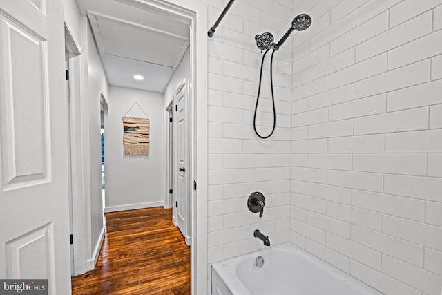 bathroom featuring hardwood / wood-style flooring and tiled shower / bath