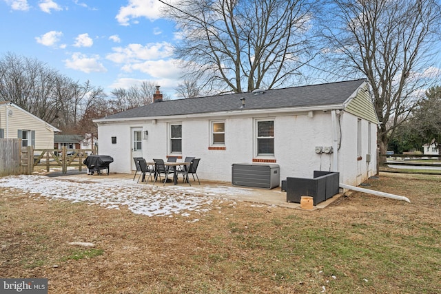 rear view of house featuring a lawn and a patio area