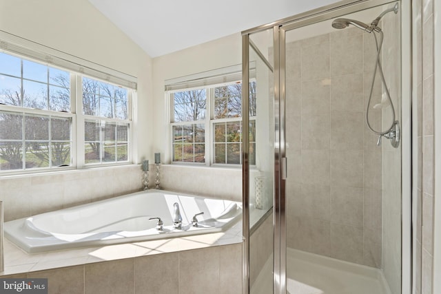 bathroom with lofted ceiling and shower with separate bathtub