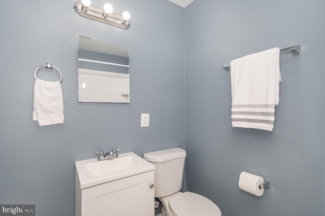 bathroom featuring toilet and vanity