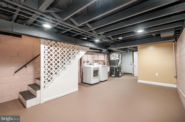 basement with heating unit and washing machine and dryer