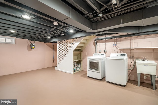 basement featuring sink and washing machine and dryer