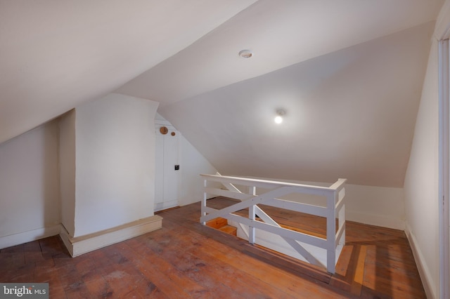 bonus room with lofted ceiling and dark hardwood / wood-style floors