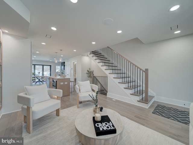 living room featuring light hardwood / wood-style floors and sink