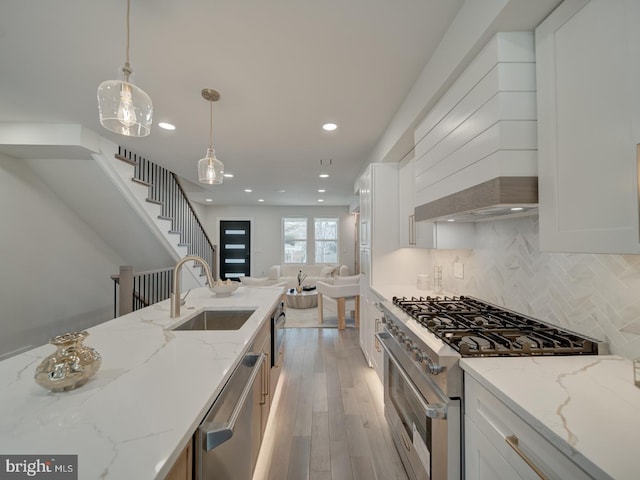 kitchen with stainless steel appliances, sink, and white cabinets