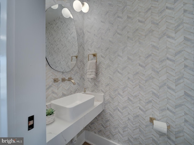 bathroom featuring tile walls and sink