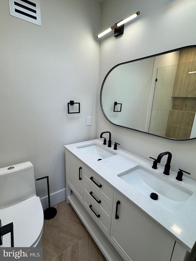 bathroom featuring vanity and toilet