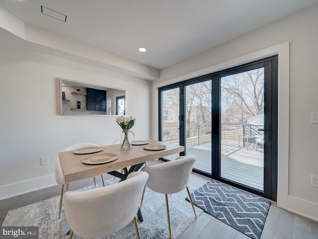 dining area with hardwood / wood-style floors