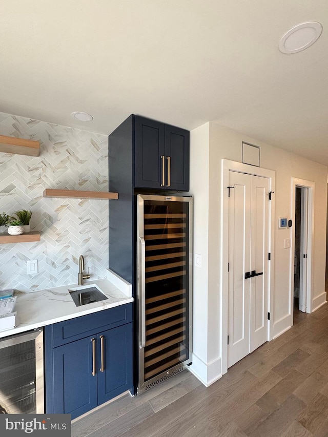 bar with wine cooler, sink, tasteful backsplash, and dark hardwood / wood-style flooring