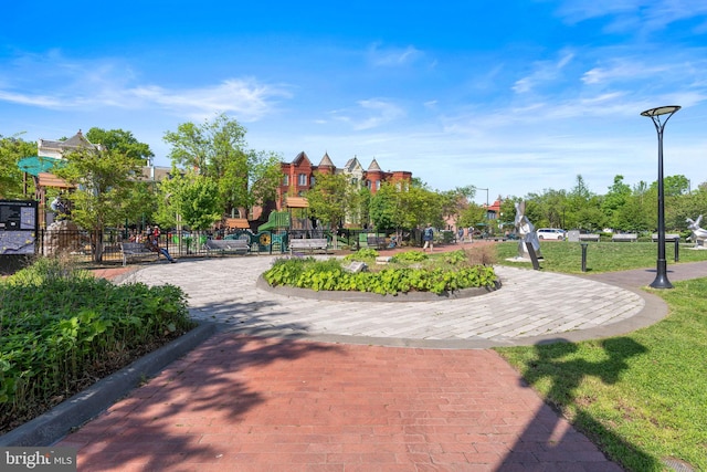 view of property's community featuring playground community and fence