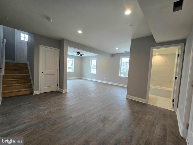 basement with ceiling fan, recessed lighting, dark wood-style flooring, baseboards, and stairs