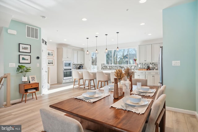 dining area featuring light wood-type flooring