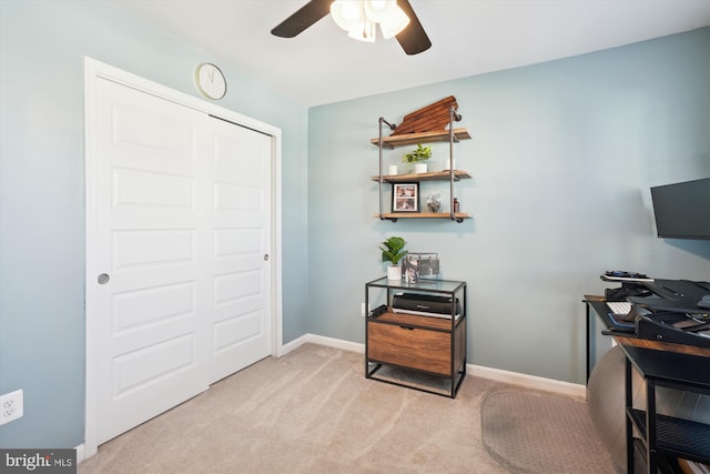 home office featuring ceiling fan and light carpet