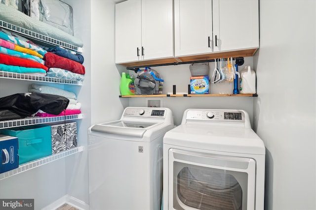 laundry area with cabinets and separate washer and dryer