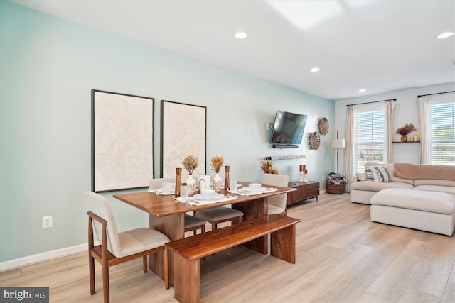 dining space with light hardwood / wood-style flooring