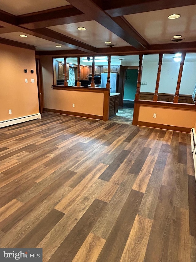 empty room with wood finished floors, beam ceiling, and baseboards