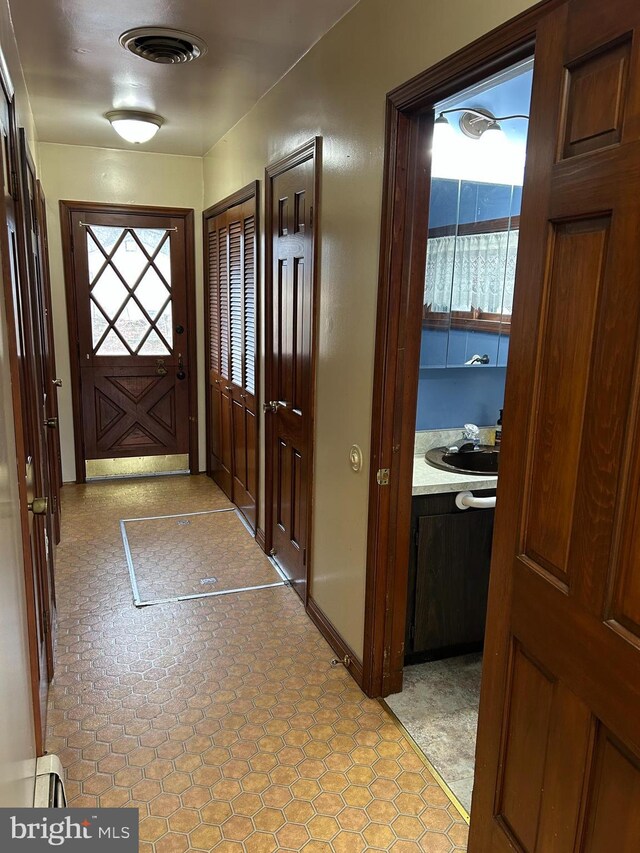 doorway featuring a sink and visible vents