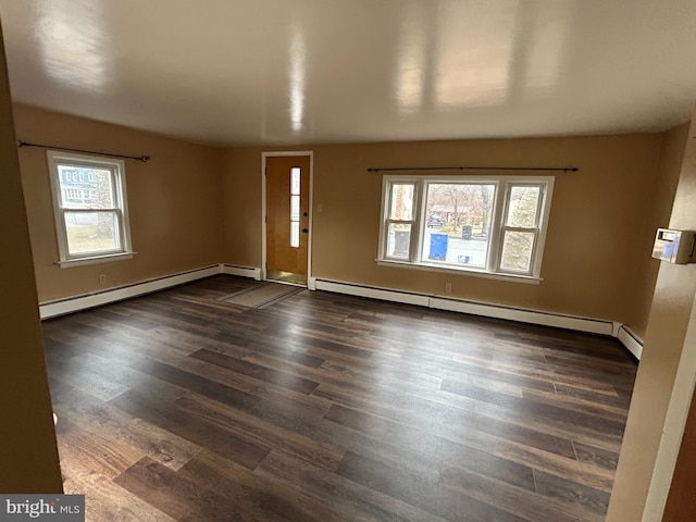 spare room with a baseboard radiator and dark wood-style flooring