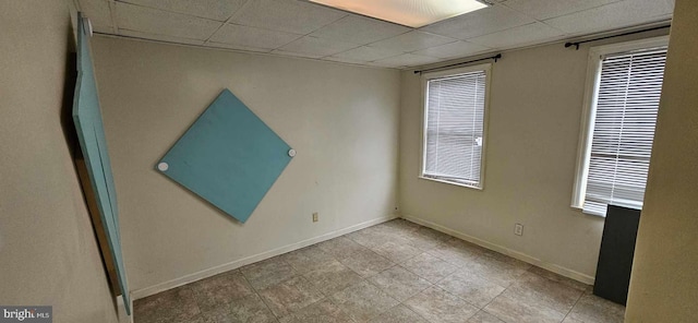 unfurnished room featuring a paneled ceiling