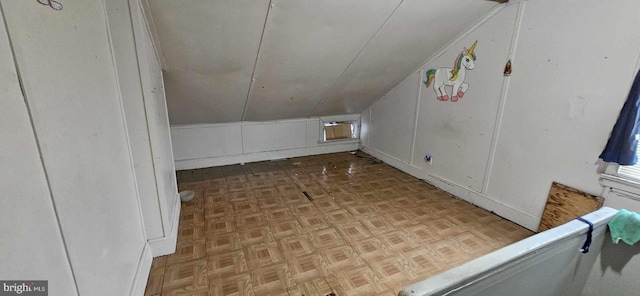 bonus room with lofted ceiling and light parquet floors