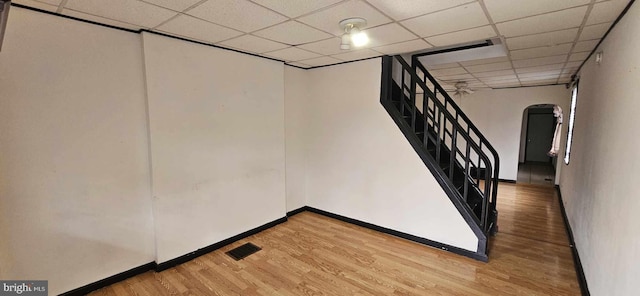 basement with wood-type flooring and a drop ceiling