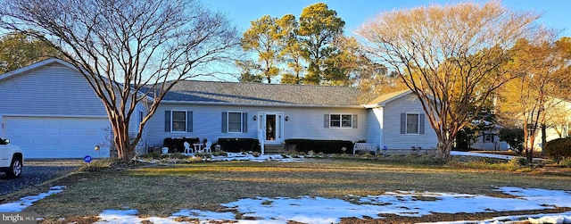 single story home featuring a garage, entry steps, and driveway