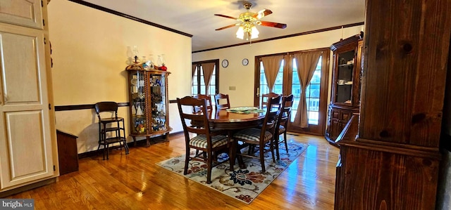 dining space featuring ceiling fan, ornamental molding, wood finished floors, and a wealth of natural light