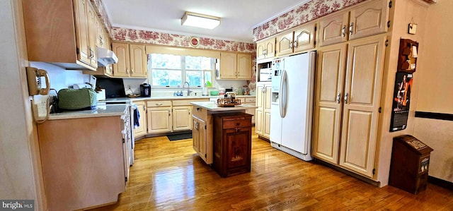 kitchen featuring electric range, a kitchen island, light countertops, light wood-type flooring, and white fridge with ice dispenser