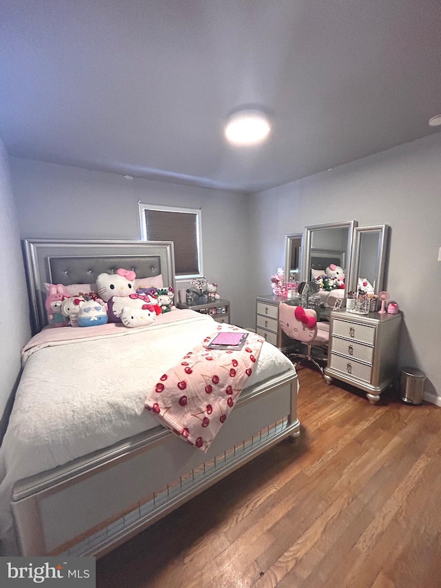 bedroom with hardwood / wood-style flooring