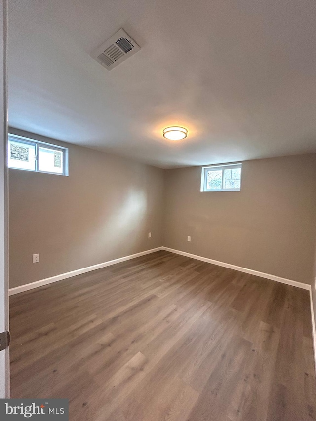 basement with hardwood / wood-style flooring