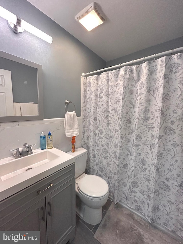 bathroom featuring toilet and vanity