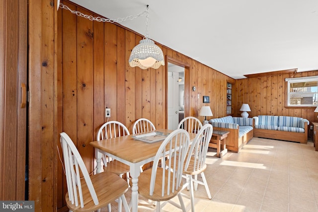 dining space featuring wooden walls