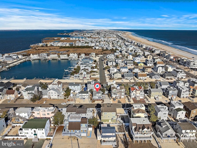 birds eye view of property with a water view and a view of the beach